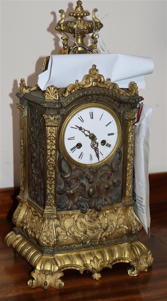 A bronze ormolu mantel clock with silk suspension